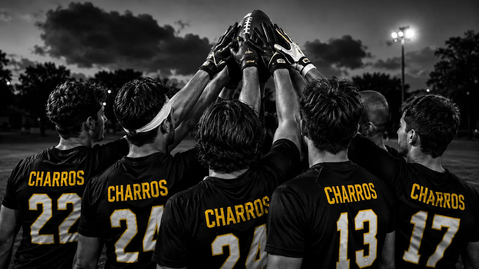 Charros squad huddled together with hands raised under a stormy sky